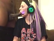 Towheaded homemade gal sucks a dark-hued pecker while frolicking video games